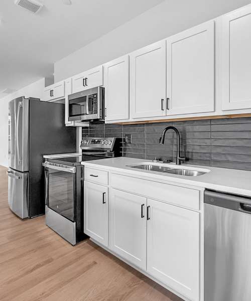Stainless steel appliances and white countertops in kitchen at Cityville on 9th in Des Moines, Iowa