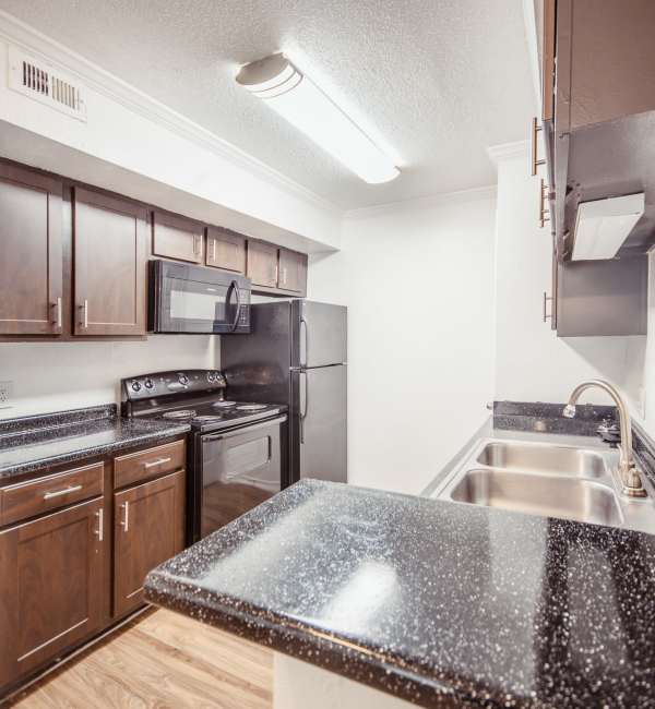 Kitchen with wooden cabinets at Henry Heights in Austin, Texas