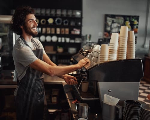 A barista prepares coffee near University Lofts at Greensborough Village, Jonesboro, Arkansas
