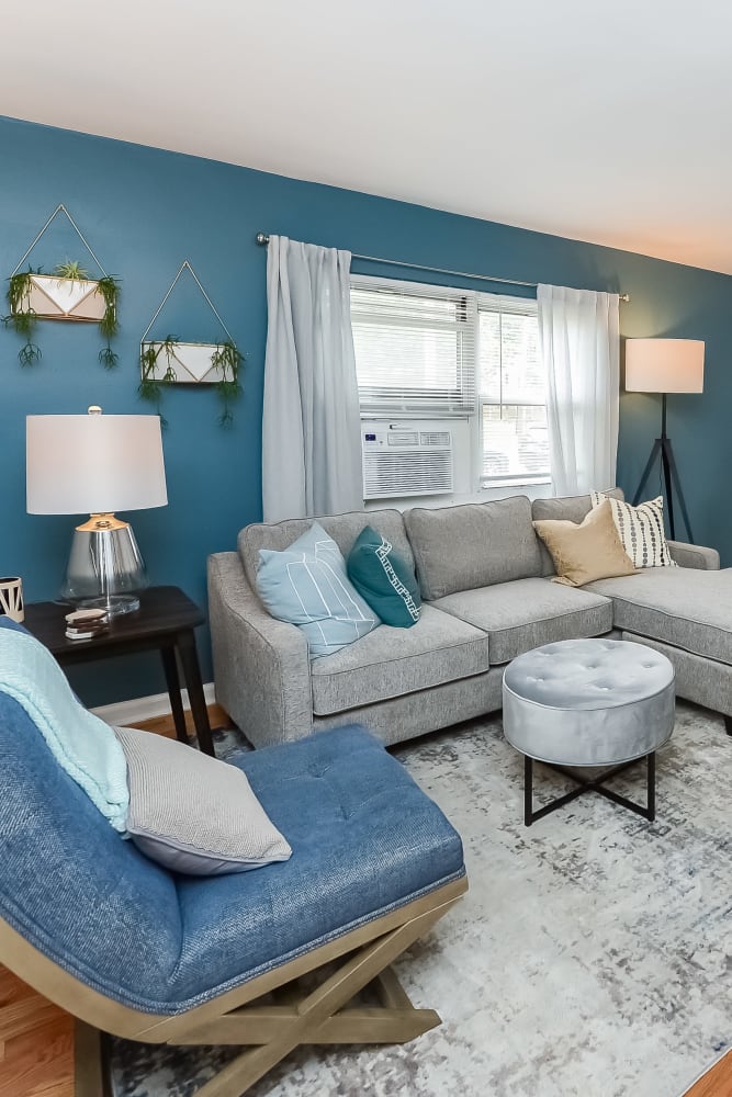 Model living room with wood flooring in a home at Elmwood Village Apartments & Townhomes in Elmwood Park, New Jersey