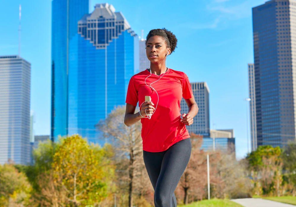 Resident going for a run through a local park near The Abbey at Energy Corridor in Houston, Texas