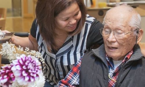 A volunteer with a resident at Nikkei Manor in Seattle, Washington