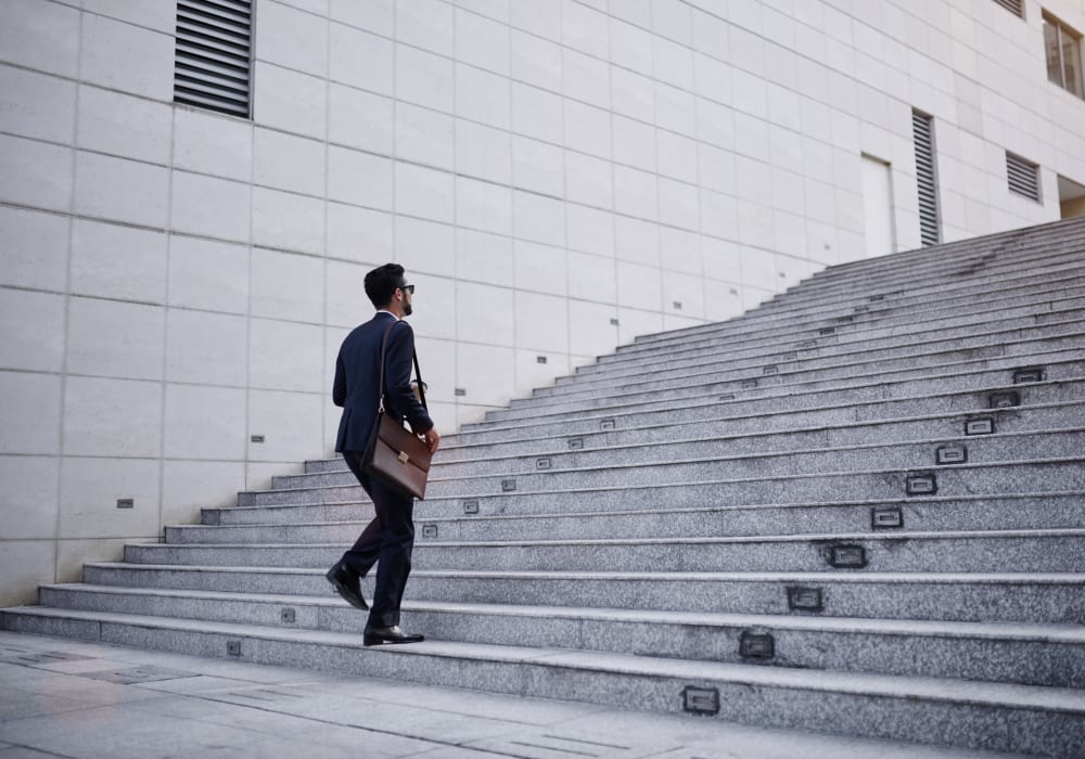 Resident walking up the steps to his downtown office near Sofi Warner Center in Woodland Hills, California