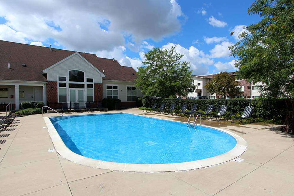 Beautiful resort-style swimming pool with lounge chairs at Riverstone Apartments in Bolingbrook, Illinois