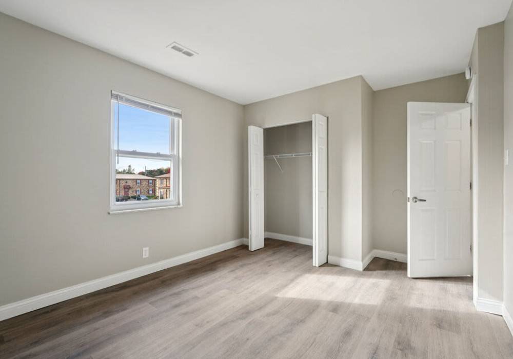 Unfurnished bedroom showing wooden flooring with closet at Charleston Square Apartments in Columbus, Indiana