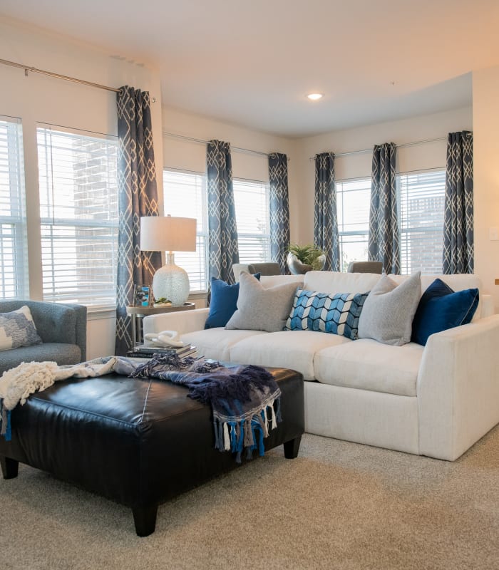 Spacious living room with large windows at Artisan Crossing in Norman, Oklahoma