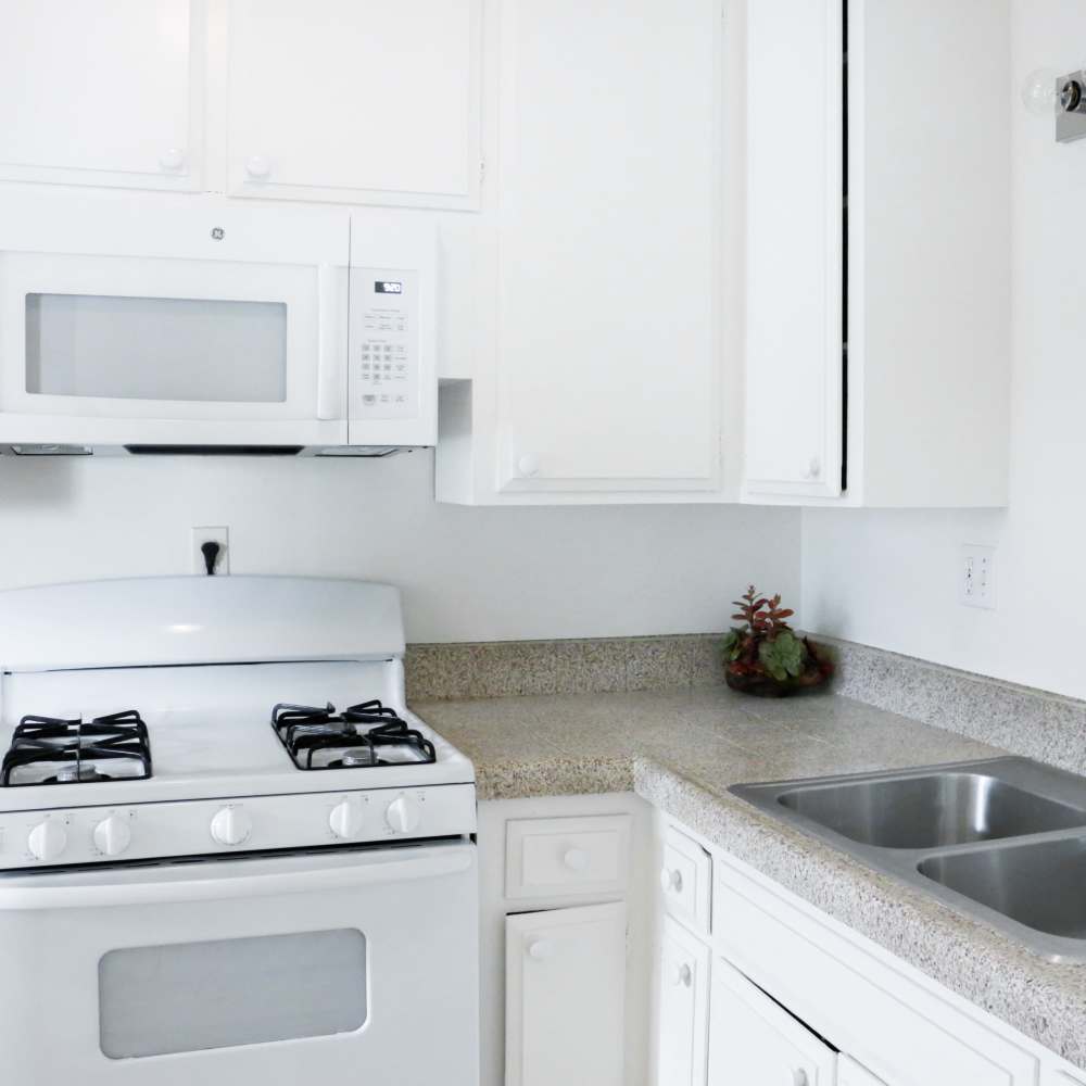 Kitchen with appliances at Huntington Reef in Huntington Beach, California