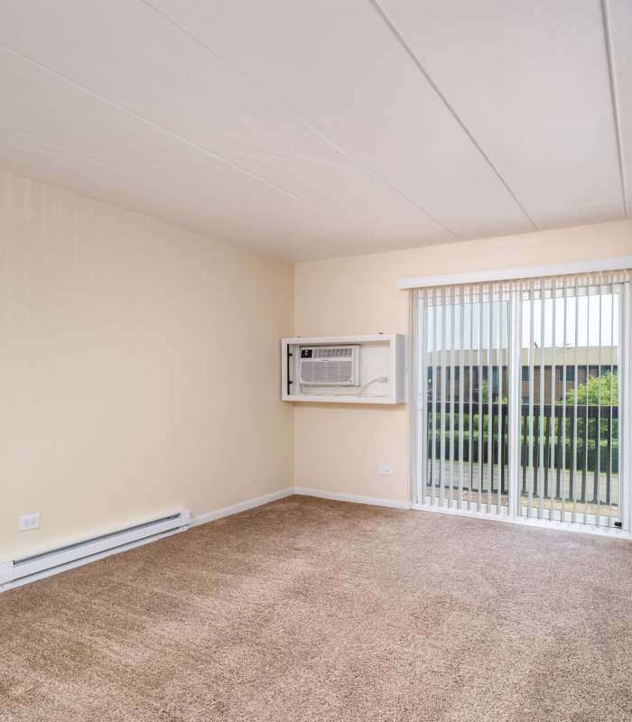 Living room with air conditioning at Regents Park Apartments in Bensenville, Illinois