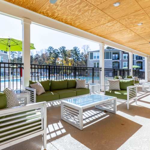 Outdoor lounge seating area near pool at Magnolia South in Holly Springs, North Carolina