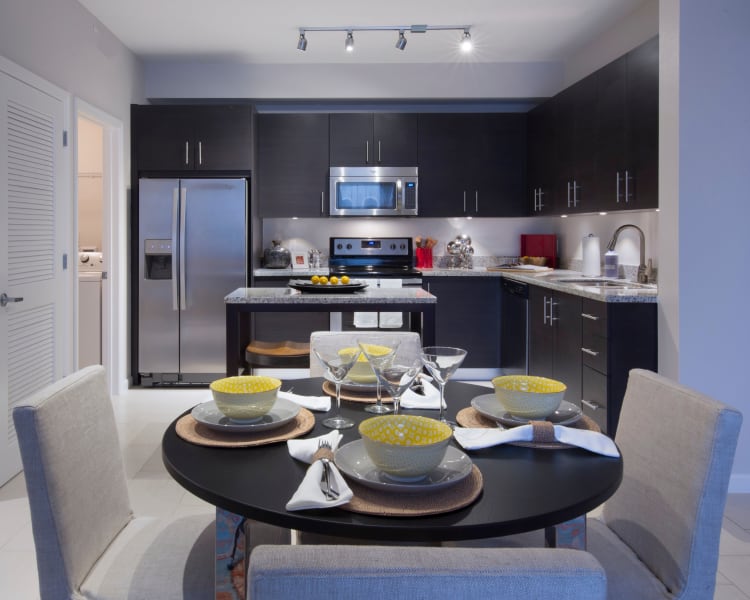 Spacious open floor plan with tiled floors in a model home at Doral Station in Miami, Florida