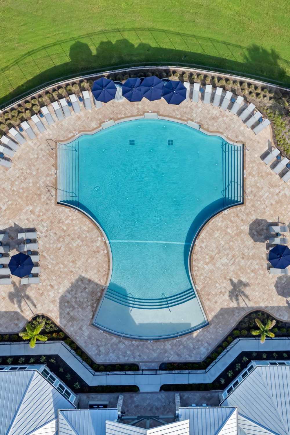 Aerial view of resort-style pool with lounge layout at The Carlton At Lake Dexter in Winter Haven, Florida