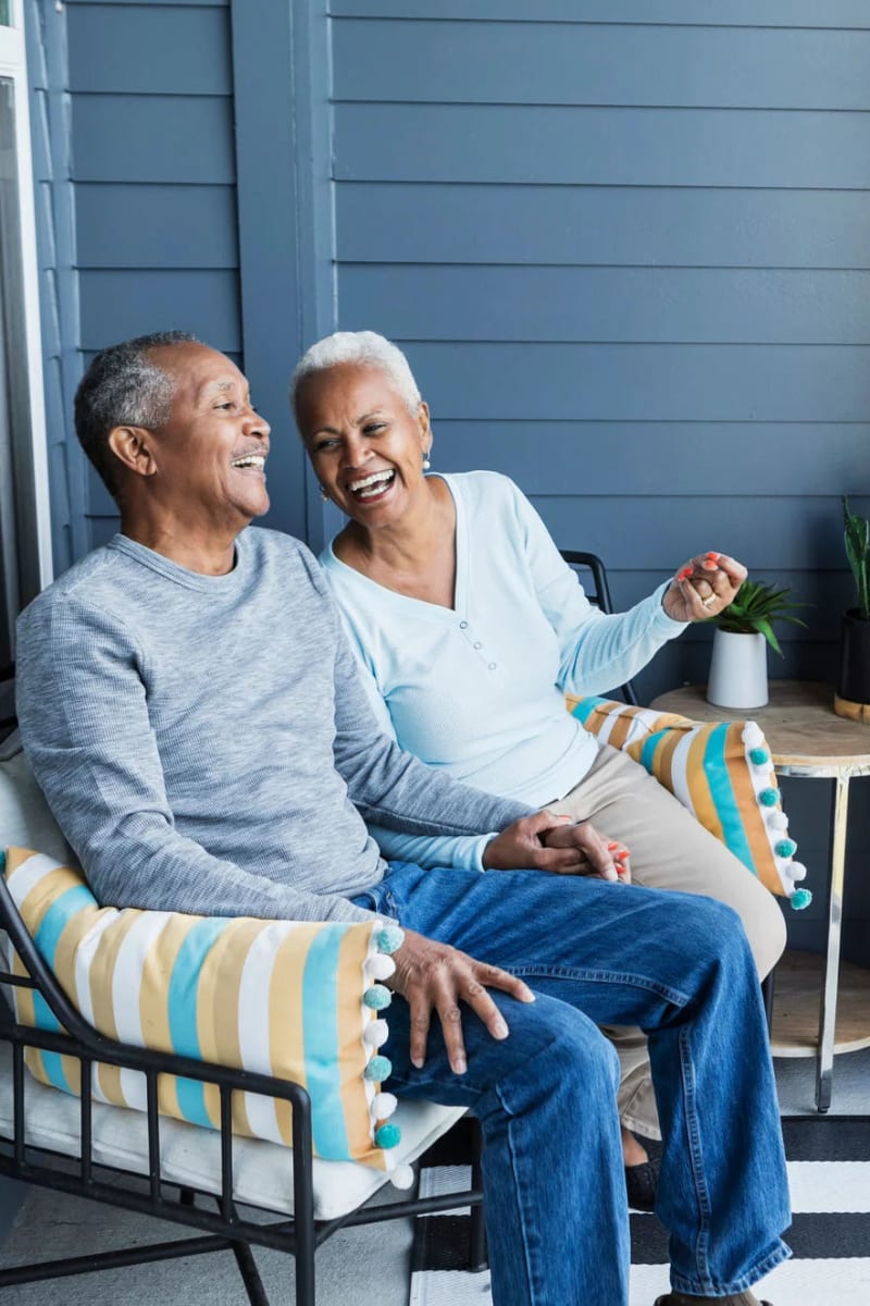 Resident couple hanging out on a porch at Carriage Inn Huntsville in Huntsville, Texas