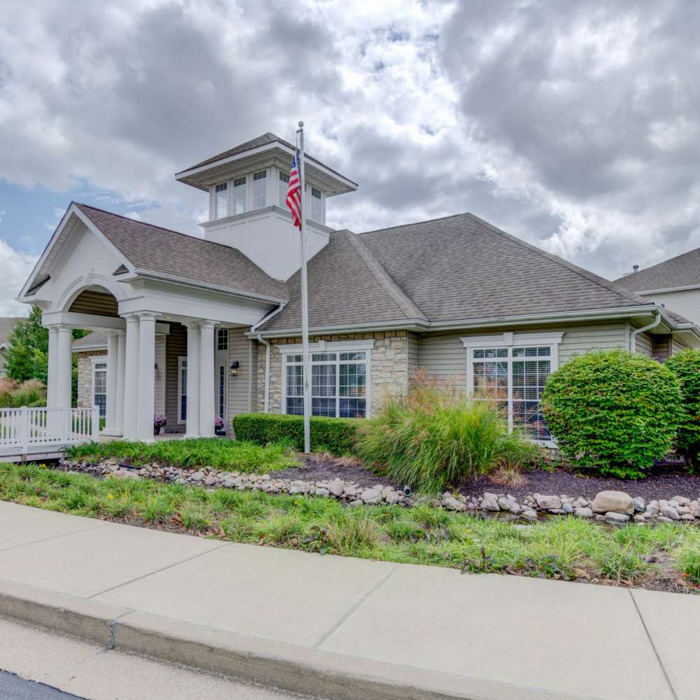 Charming entrance with lush landscaping at Boulder Springs in Maryland Heights, Missouri.