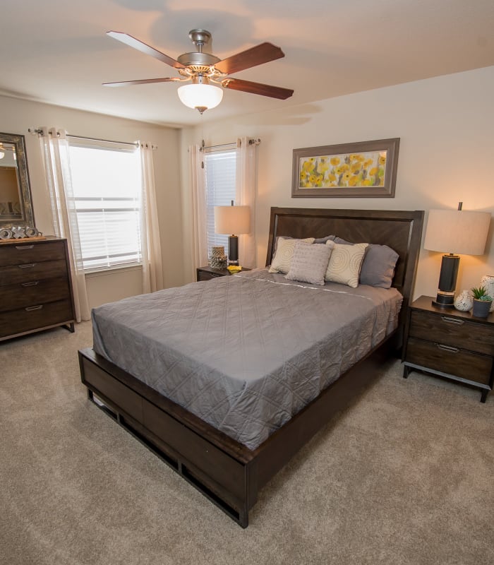 Spacious carpeted bedroom at Cottages at Tallgrass Point Apartments in Owasso, Oklahoma