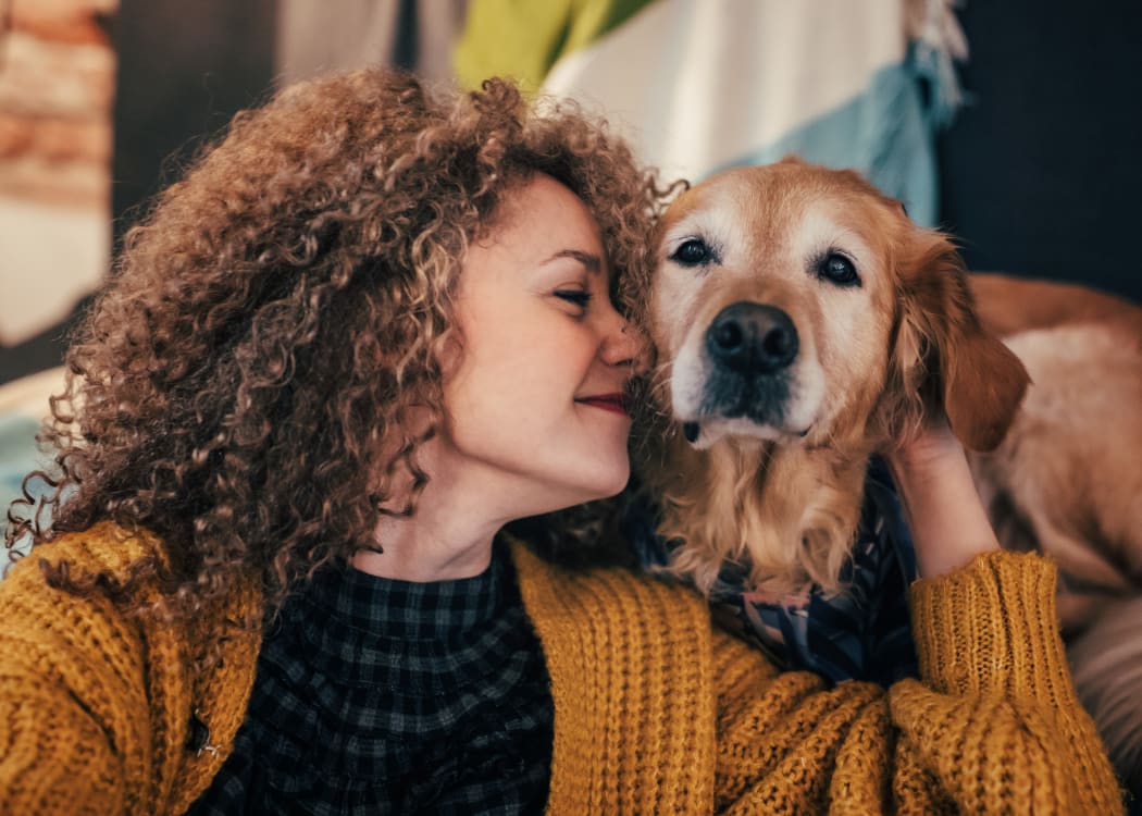Woman with her dog at Vistas at Stony Creek Apartments
