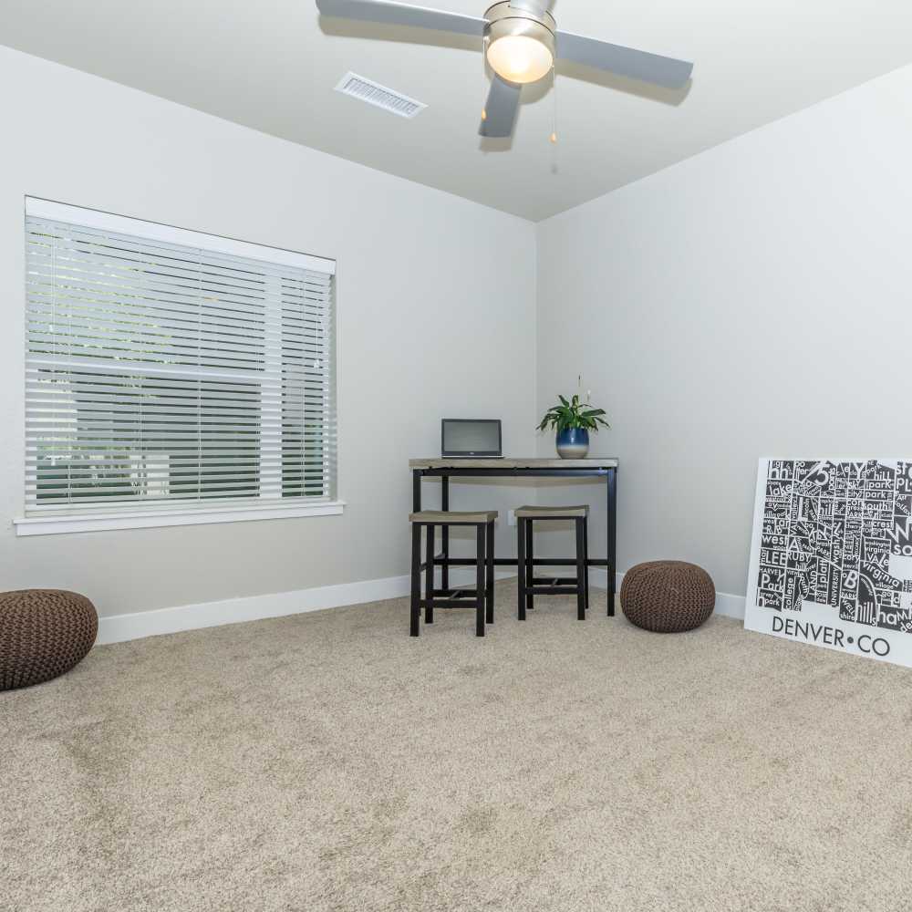 Unfurnished bedroom with carpet flooring and large window at Park Place Olde Town Apartments in Arvada, Colorado