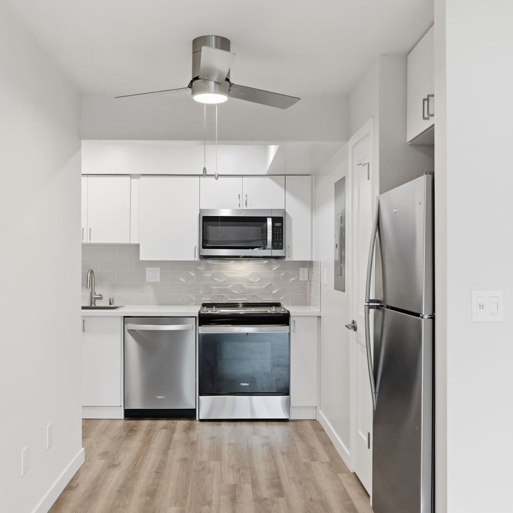 Kitchen with white cabinets and stainless steel appliances at Fayette Arms Apartments in Mountain View, California, 