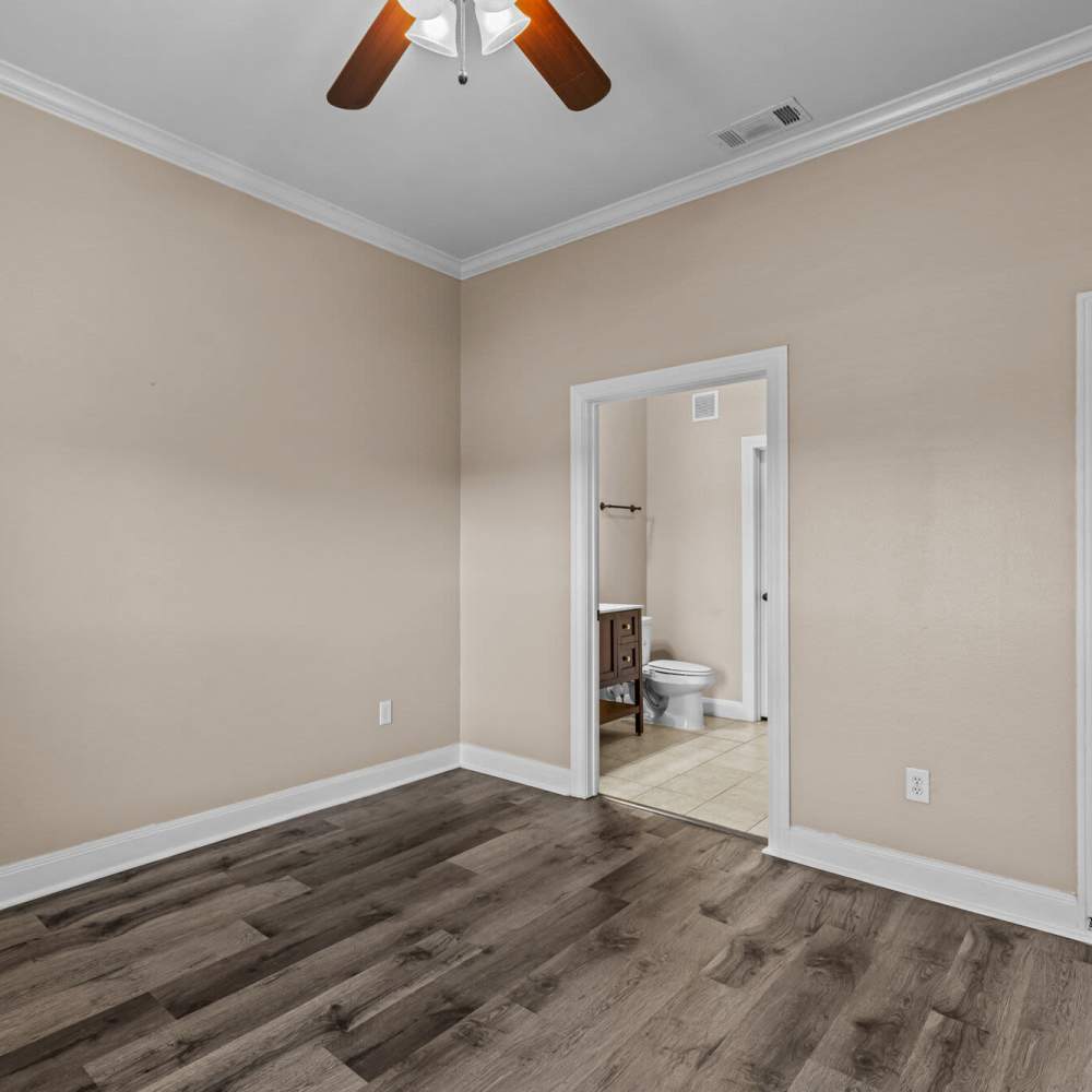 Bedroom with attached bathroom at The Arbors of Mineola in Mineola. TX