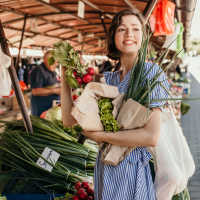 Resident buying vegetables near Pine Oaks Apartments in Mesquite, Texas