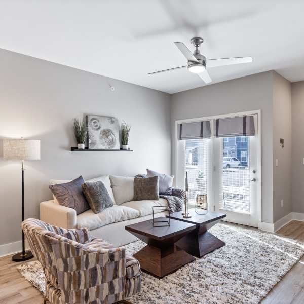 Living room with access to private balcony at Alexander Pointe Apartments in Maineville, Ohio