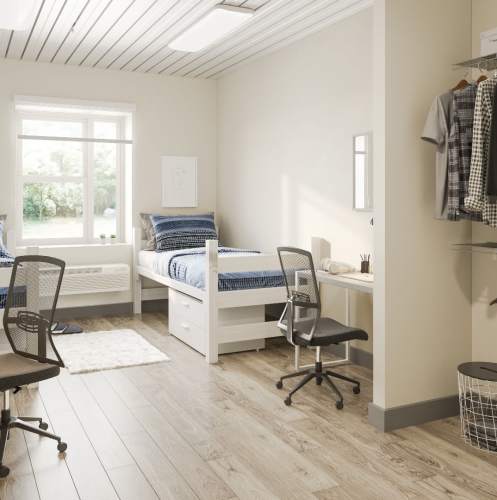 Bedroom with two beds and attached study tables along closet at Polly O'Meara Doyle Hall in Santa Rosa, California