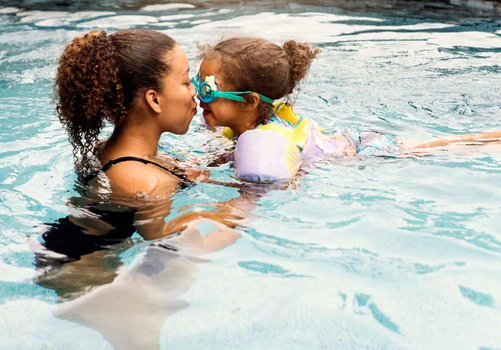 Mother and daughter having fun in pool at Boomer Creek Apartments in Stillwater, Oklahoma