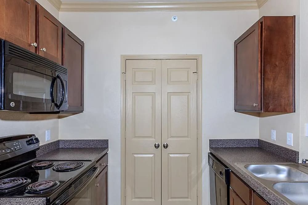 Garden Style kitchen with dark wood cabinets at Villas On Independence in Port Lavaca, Texas