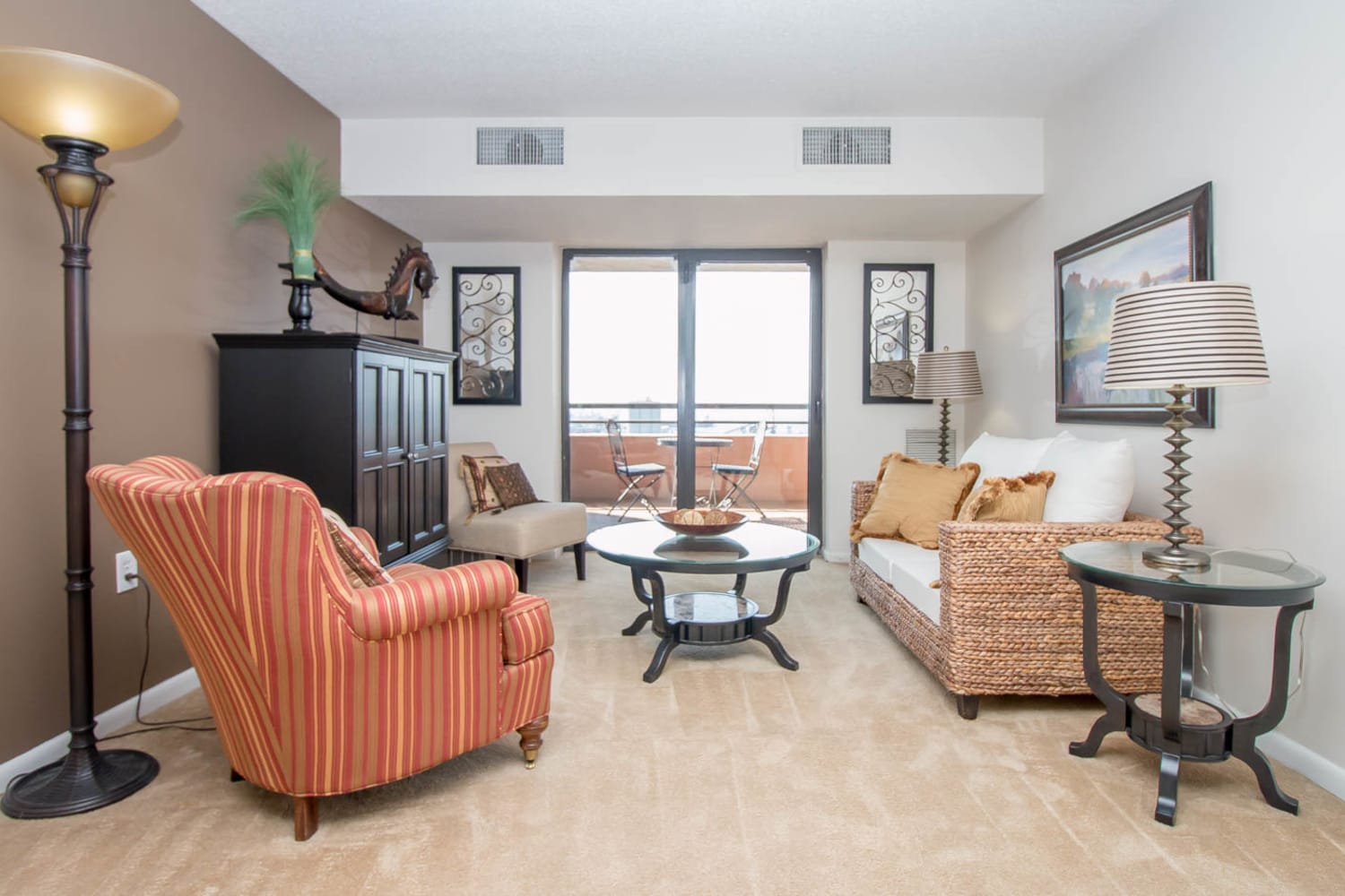 Spacious living room opening onto a private balcony at River Park Tower Apartment Homes in Newport News, Virginia