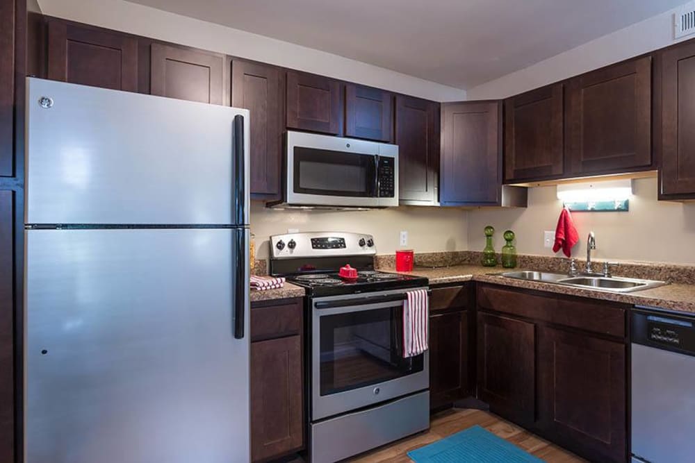 A modern kitchen with stainless-steel appliances at Sunbrook Apartments in Saint Charles, Missouri