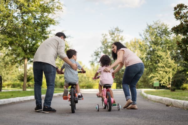 Residents pushing their kids on bikes near Magnolia Gardens in Brookhaven, Georgia