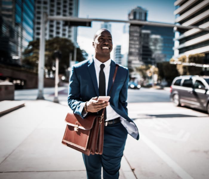 Resident walking to his job from his new home at 21 West Street in New York, New York