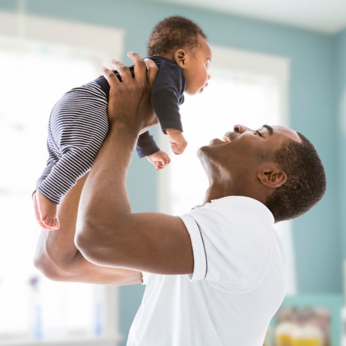 A father holding his son at Serra Mesa in Oceanside, California