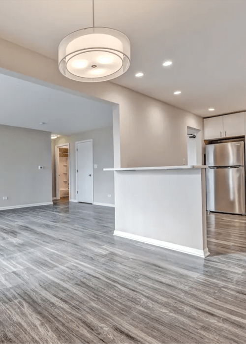 Living room with access to kitchen at Stonebridge in Arlington Heights, Illinois