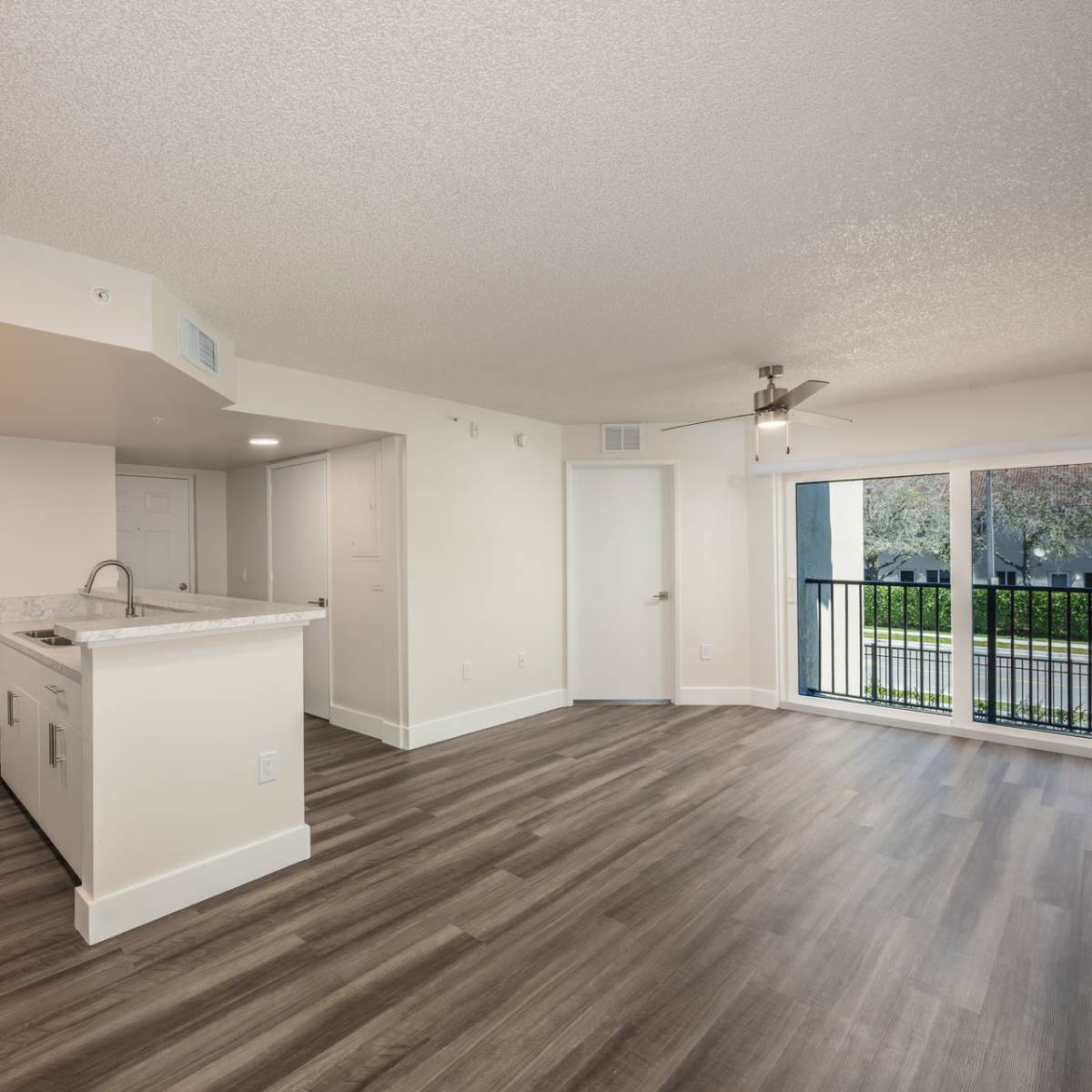 Living room and open kitchen of an apartment at Ernie Martin Villas in Miami, Florida