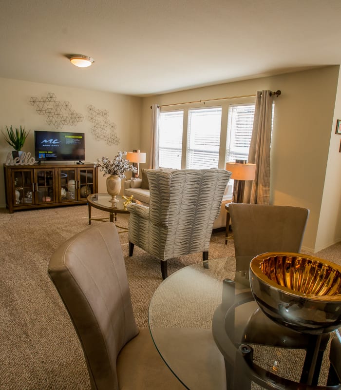 Carpeted living room at Icon at Broken Arrow in Broken Arrow, Oklahoma
