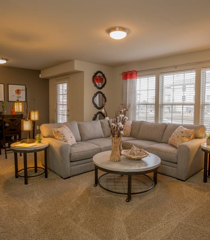 Spacious living room with large windows at Portofino Apartments in Wichita, Kansas