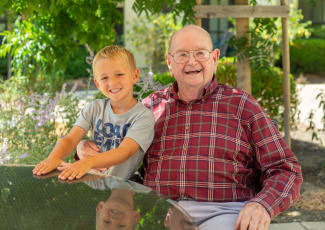 Happy resident and grandson at senior living in Mount Pleasant