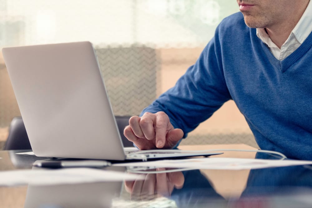 Man browsing on his laptop at McKinnon Apartments in Sacramento, California