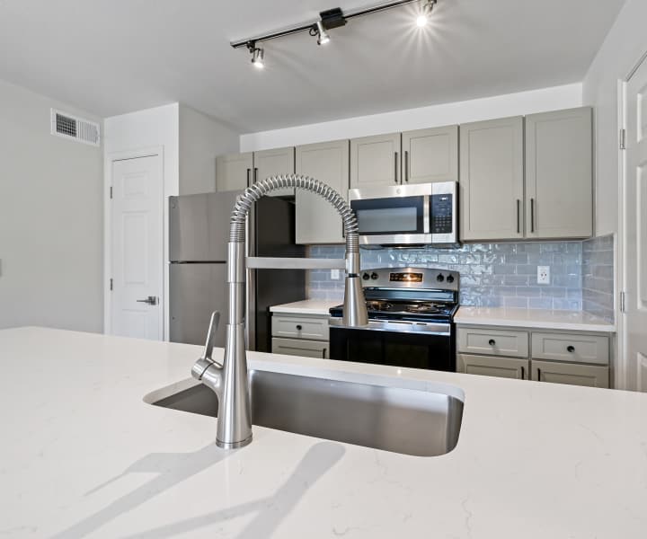 Kitchen with granite countertops and stainless-steel appliances at Seacrest in Katy, Texas