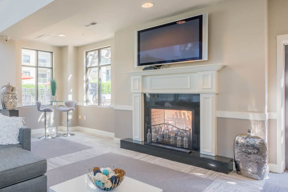 Comfortable fireplace seating area in the clubhouse at SouthPark Morrison in Charlotte, North Carolina