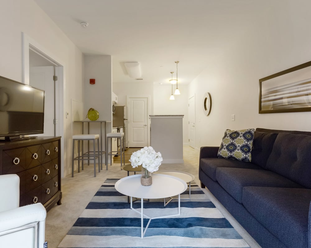 Spacious living room with wood style flooring at The Sound at Gateway Commons in East Lyme, Connecticut
