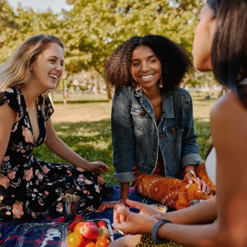 Friends having a picnic at the park near Strata Apartments in Denver, Colorado