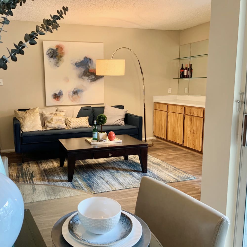 Living room with wood-style flooring at Oak Ridge Apartments in San Antonio, Texas