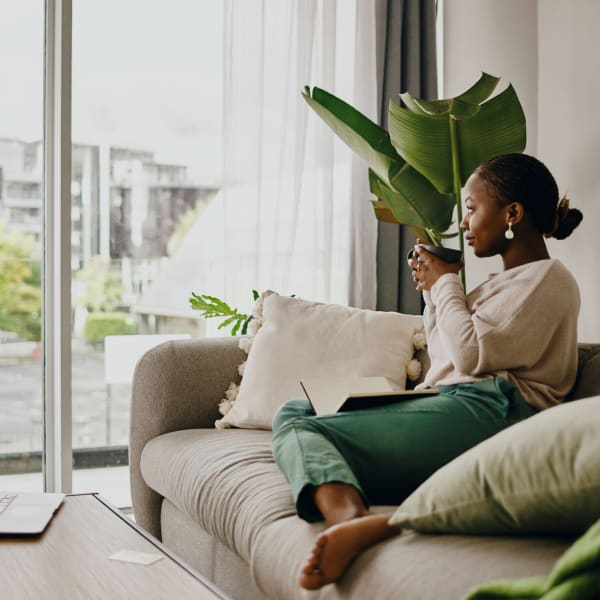 A resident sips coffee in her apartment at CovePointe at The Landings, Norfolk, Virginia