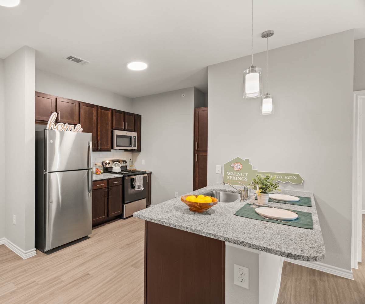 Modern kitchen with breakfast bar at Walnut Springs in Seguin, Texas