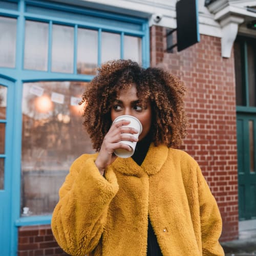 A woman sips her morning cup of coffee in Denver, Colorado