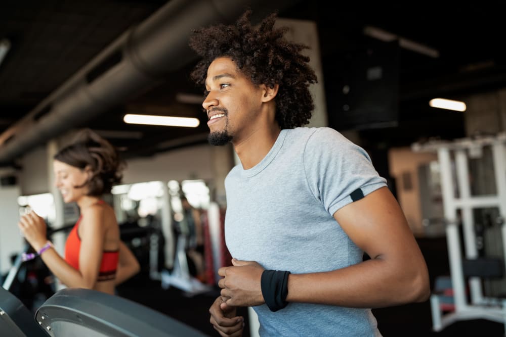 Resident running in the fitness center at Riverbend on the Charles in Watertown, Massachusetts