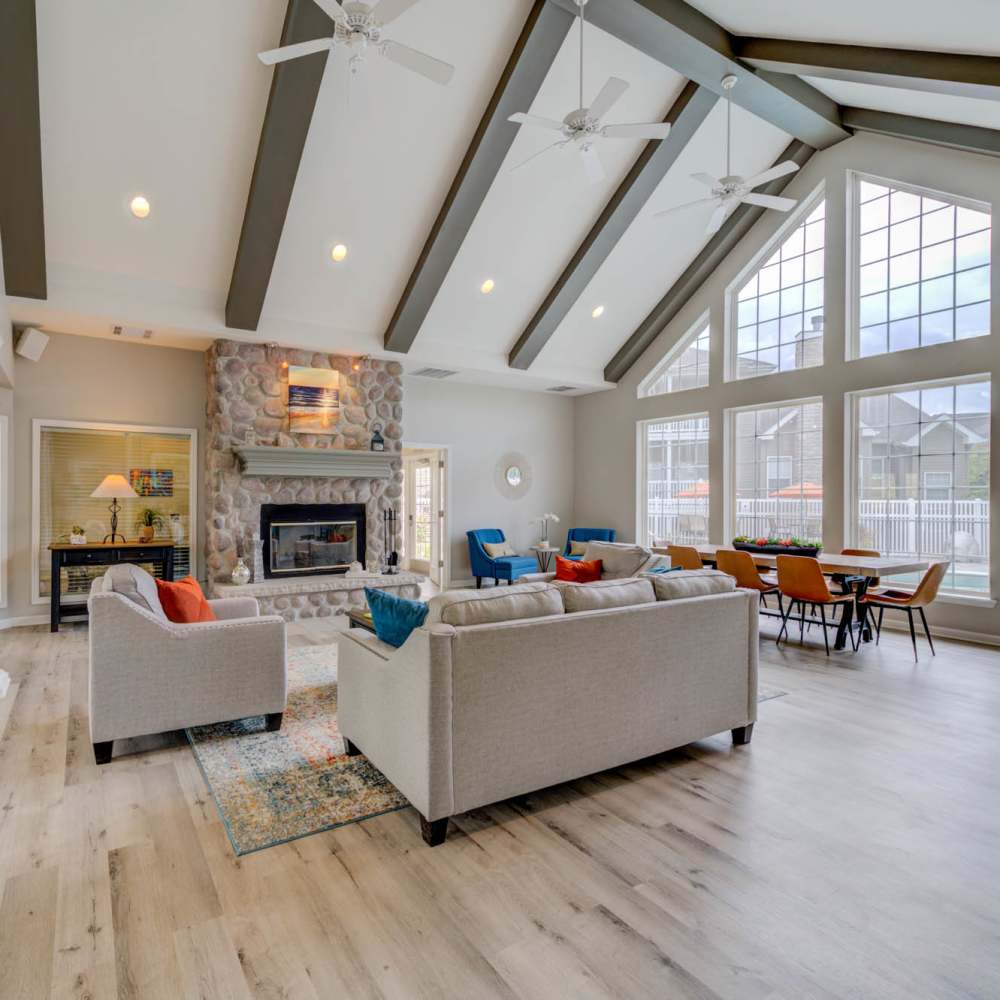 Charming living room with soaring ceilings and a stunning stone fireplace at Boulder Springs in Maryland Heights, Missouri.