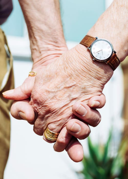  Senior couple holding hands at Grand Villa of Delray Beach East in Delray Beach, Florida