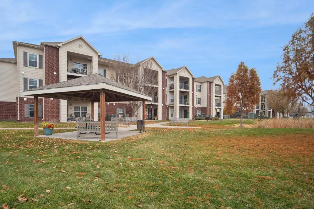 Charming community gazebo surrounded by lush greenery and stylish apartments at Villas At Meadow Springs in Ankeny, Iowa